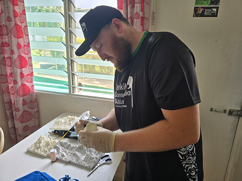 Benjamin Miles preparing a specimen container before heading out